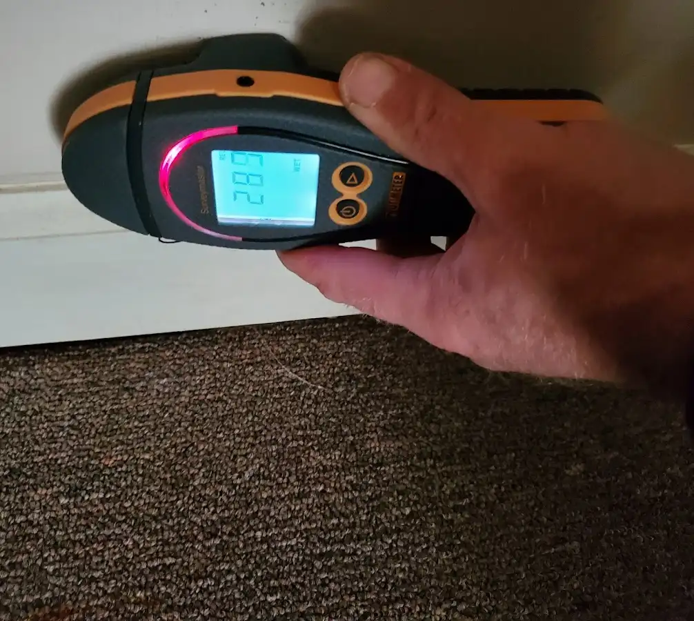 Moisture detection at baseboard during Storm Damage Restoration in Litchfield Beach